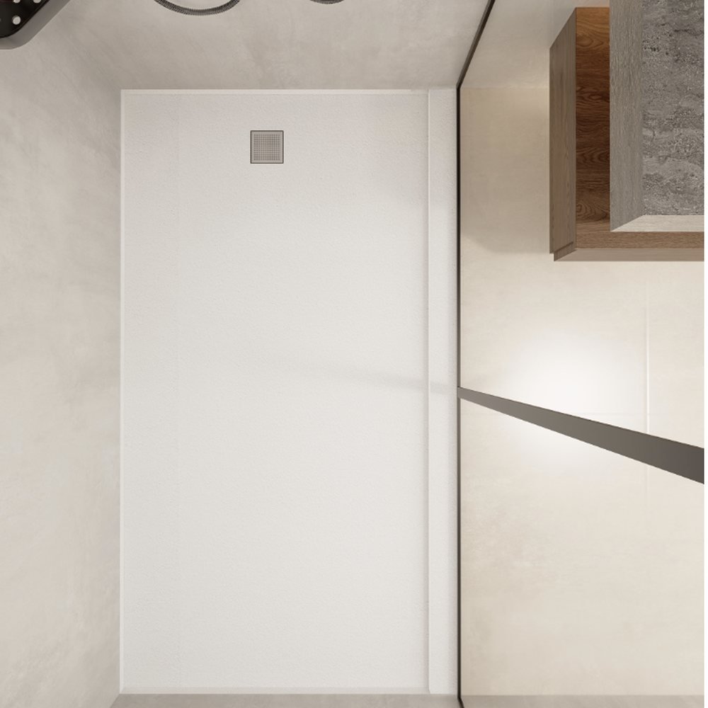 Top-down view of a Modo sintered stone shower tray set into a recess, with its factory-formed square drain.